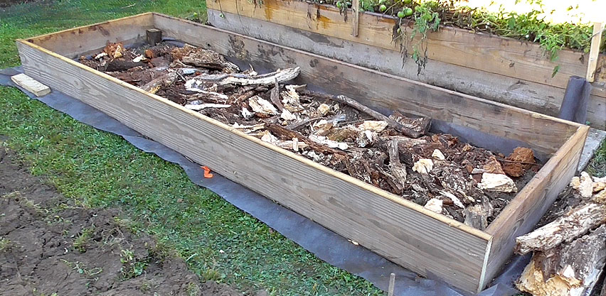 Filling Bottom of Raised Bed with Old Wood Before Adding Soil aka Kugelkultur